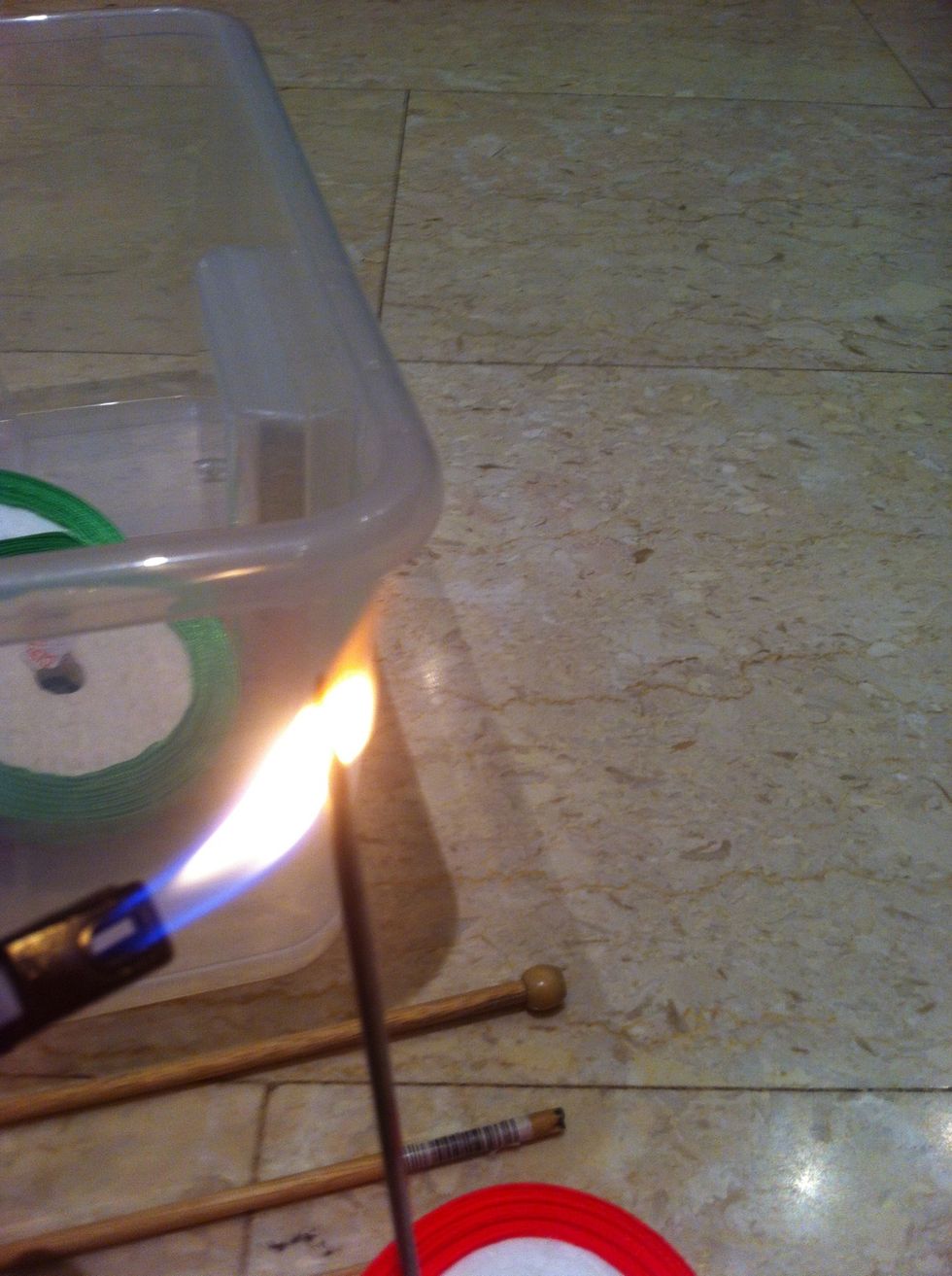 Heat the needle to make the hole in the side of the box