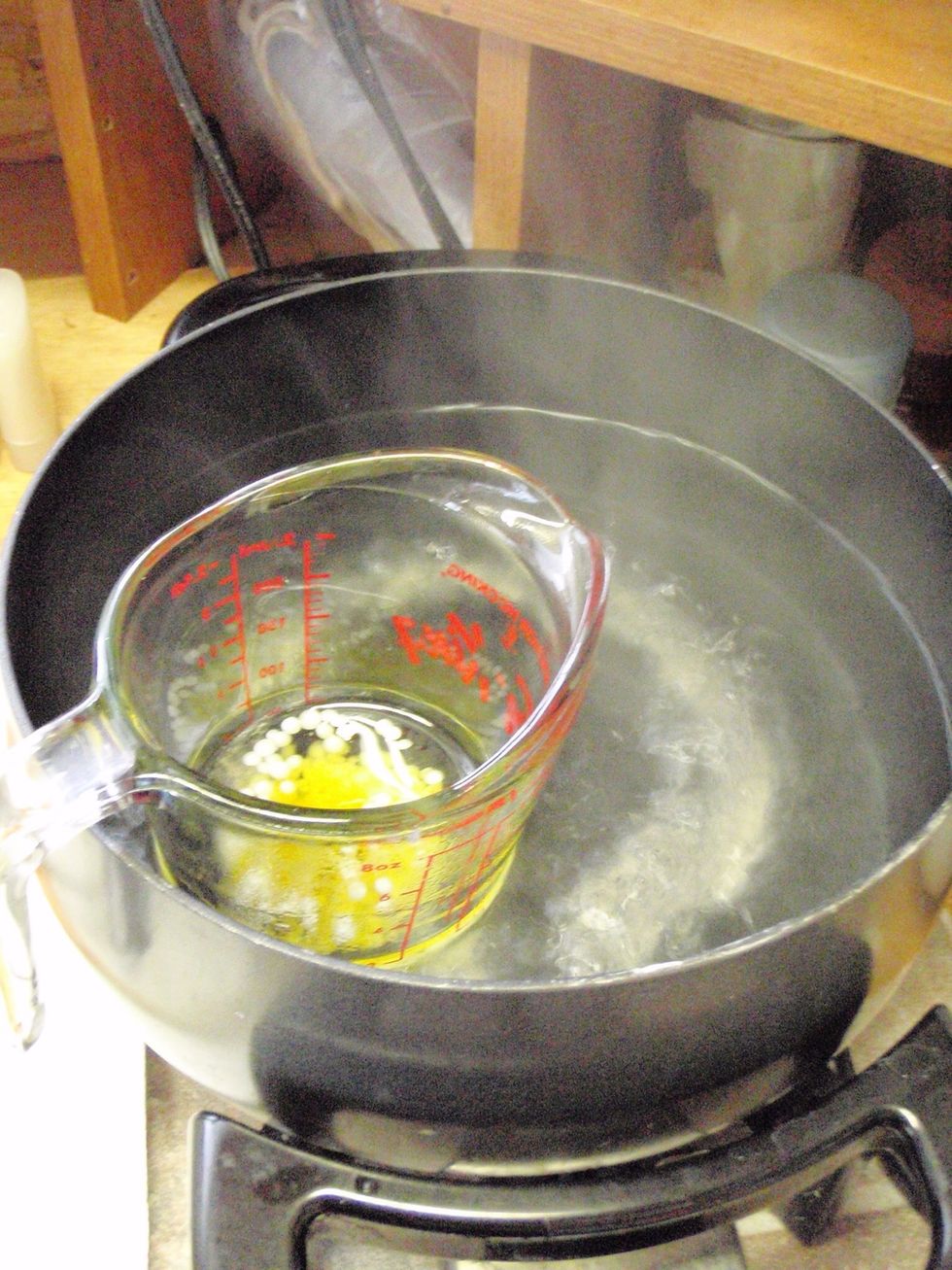 Heat the oils, butter, and wax  in a double boiler until all the solid bits have melted. When they have, remove from the heat, add your fragrance oil, then pour it all into the containers. Let cool.