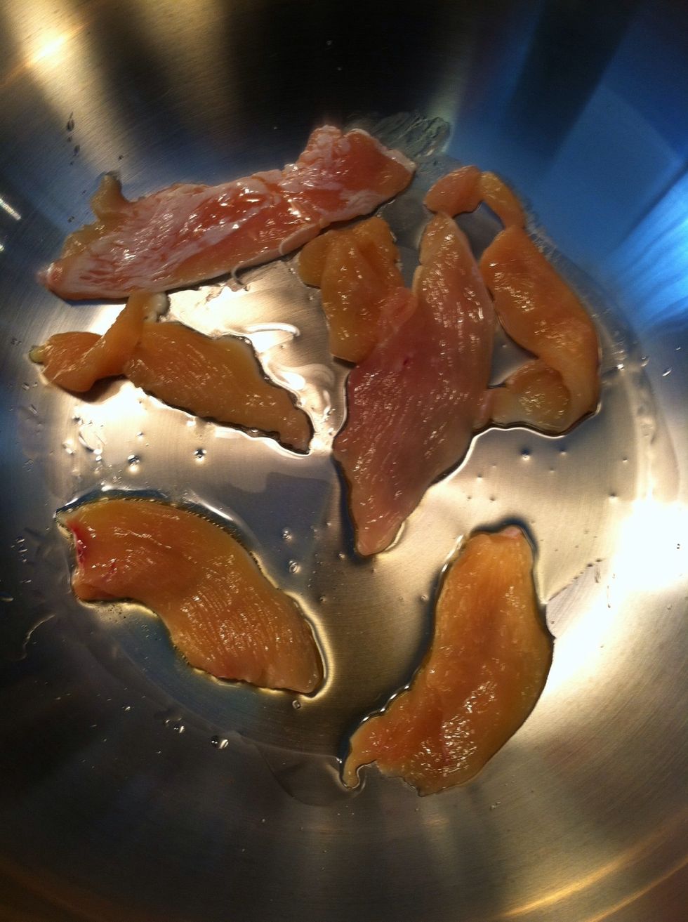 Heat the olive oil in a LARGE non-stick pan on medium heat and then begin to cook the chicken strips. You'll need a large skillet pan for this because later you'll be adding vegetables to this pan.