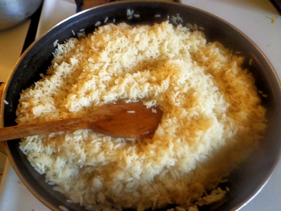 Heat the olive oil/ vegetable oil in a large skillet on a medium heat high. Add the rice and stir often until the rice is browned. Lower heat and add little water if it sticks