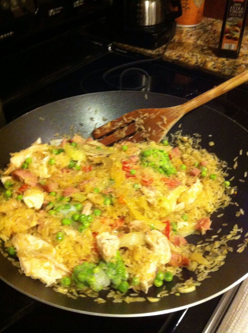 heat the pan.. add some oil and stir te onions celery and garlic .. add the chicken rice and ham... some green peas and stir...add the chicken broth... no salt ham and broth has plenty... cover well