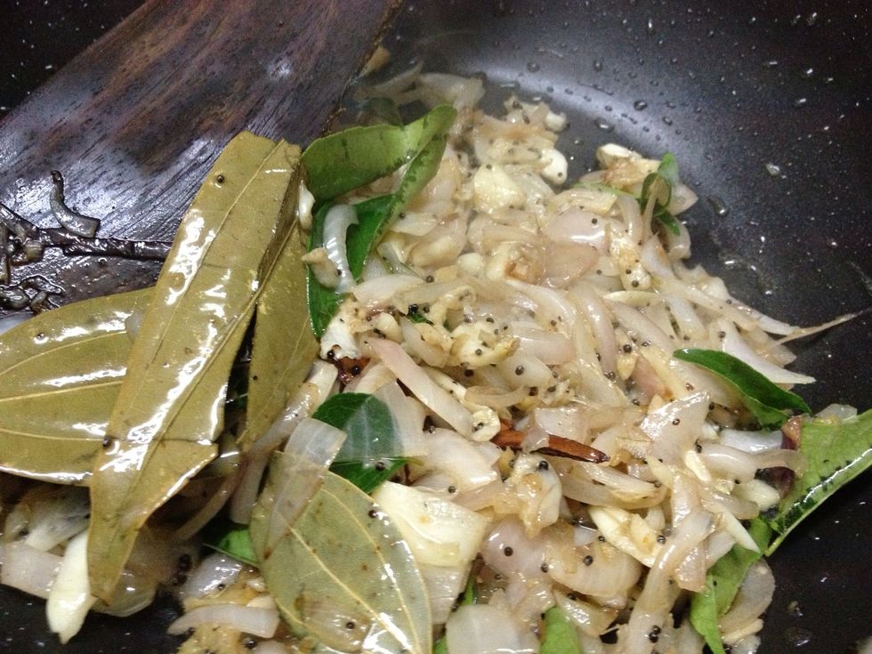 Heat the pan and pour oil, once the oil is hot, add mustard seeds and let crack it. then Cinnamon, Bay leaves, Cloves, add curry leaves, garlic, then saute well