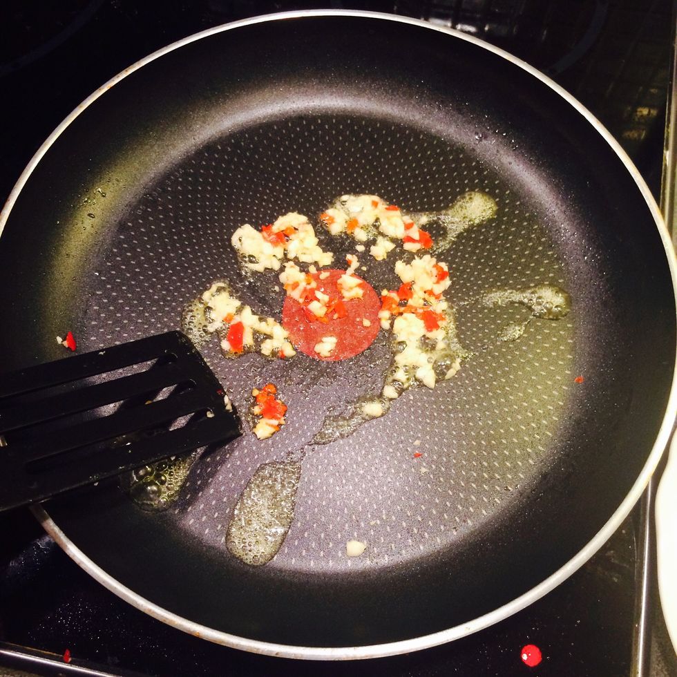 Heat the pan. Fry garlic and chili.