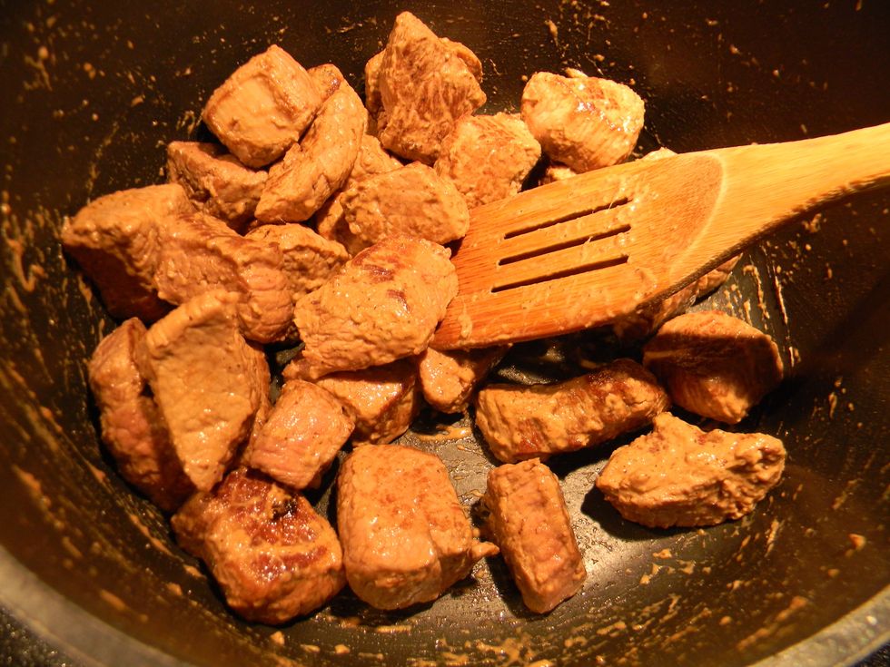 Heat the pot on medium and stir the coated meat for about 2 minutes until you notice the flour thickening.