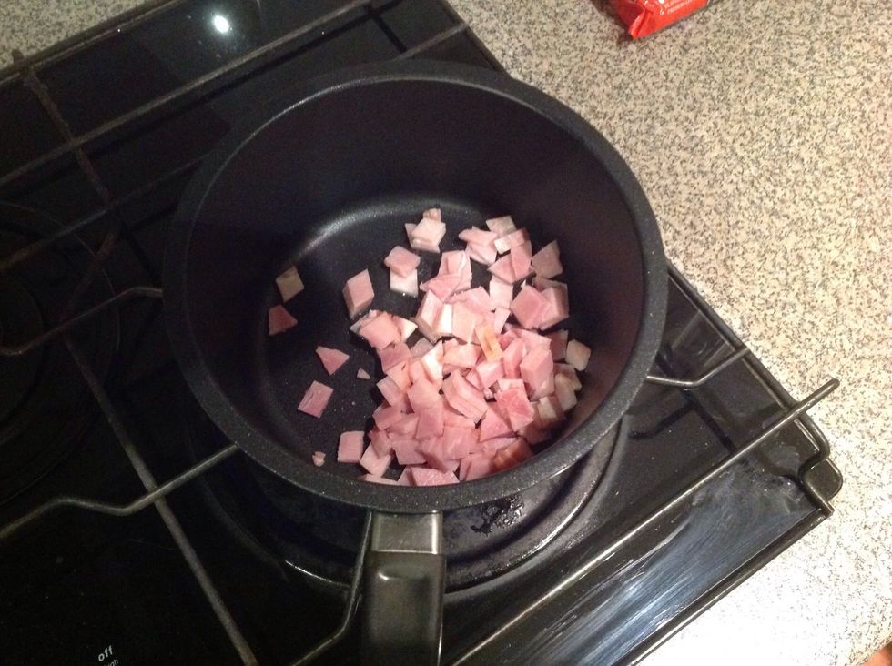 Heat the saucepan and put the bacon in and cook till hard.