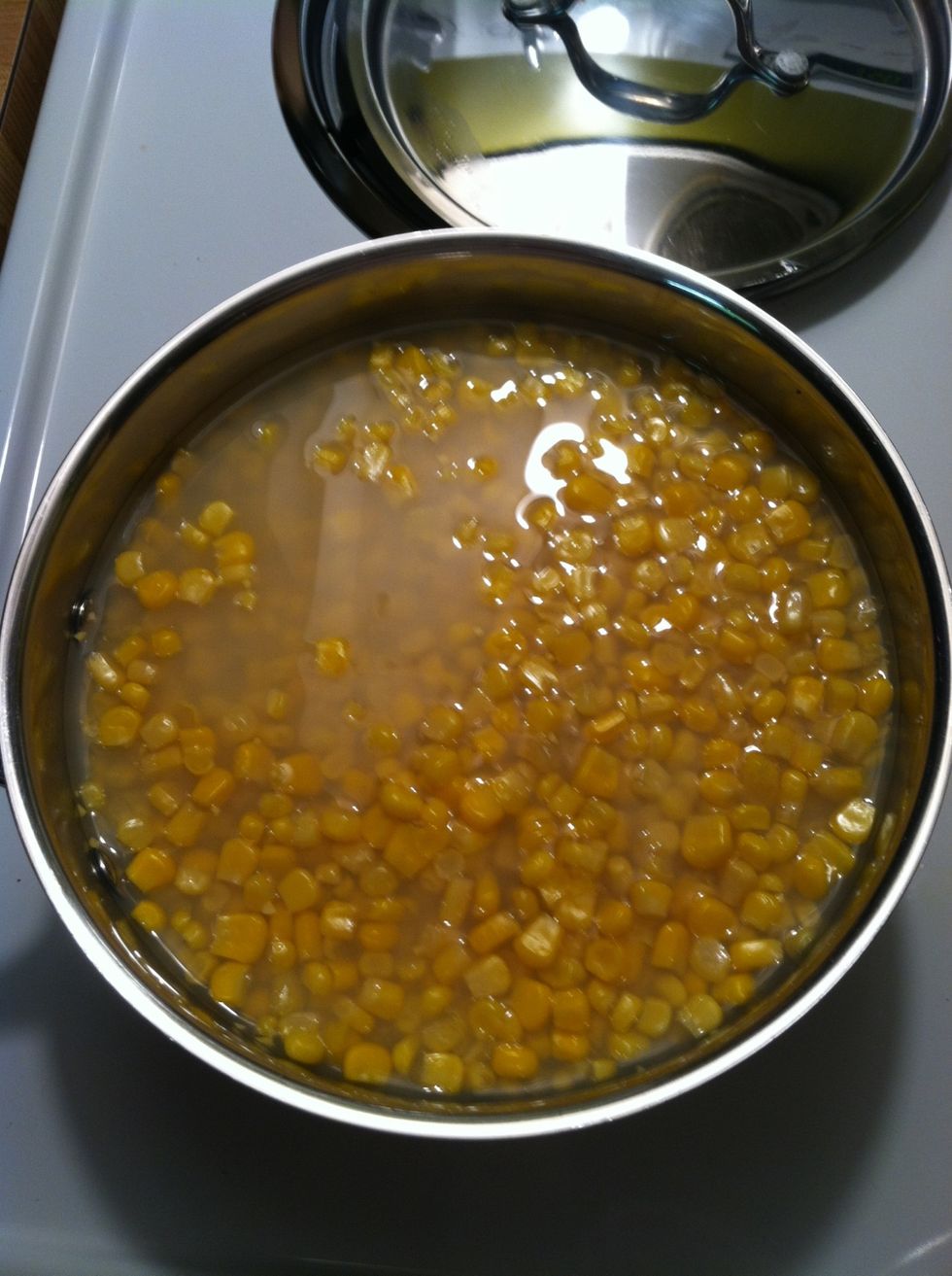 Heat through three 14.5 oz cans of sweet corn kernels.