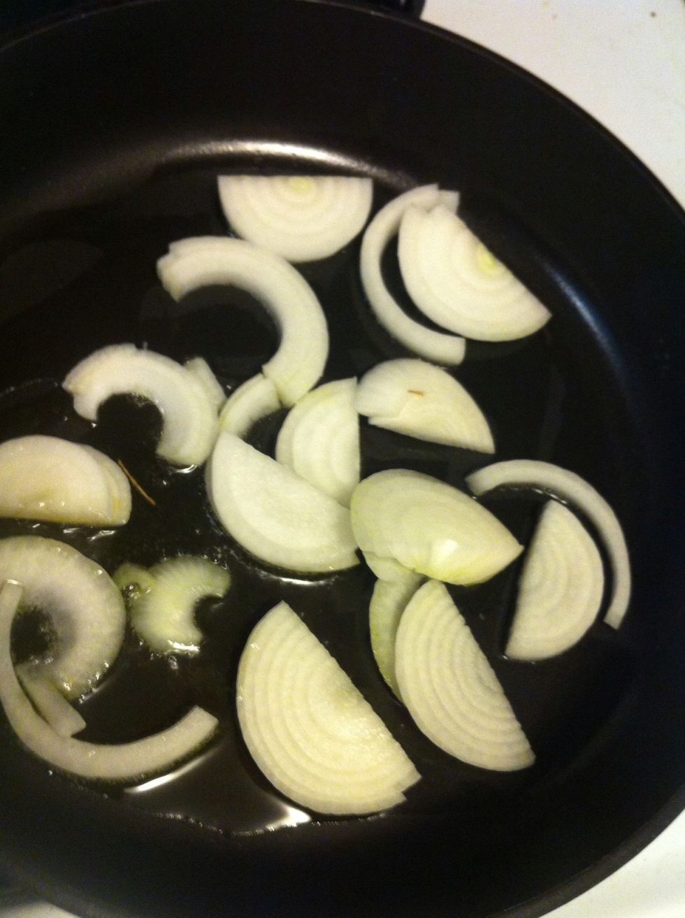 Heat up a pan with a little olive oil on medium. Make sure it's hot before you put the onion in. You'll cook them a total of about 10 minutes.