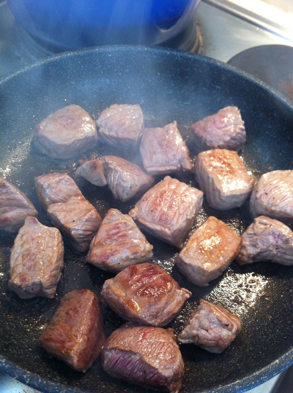Heat up a pan with some oil, add beef cubes in batches, add more oil in the next batch until all beef are browned