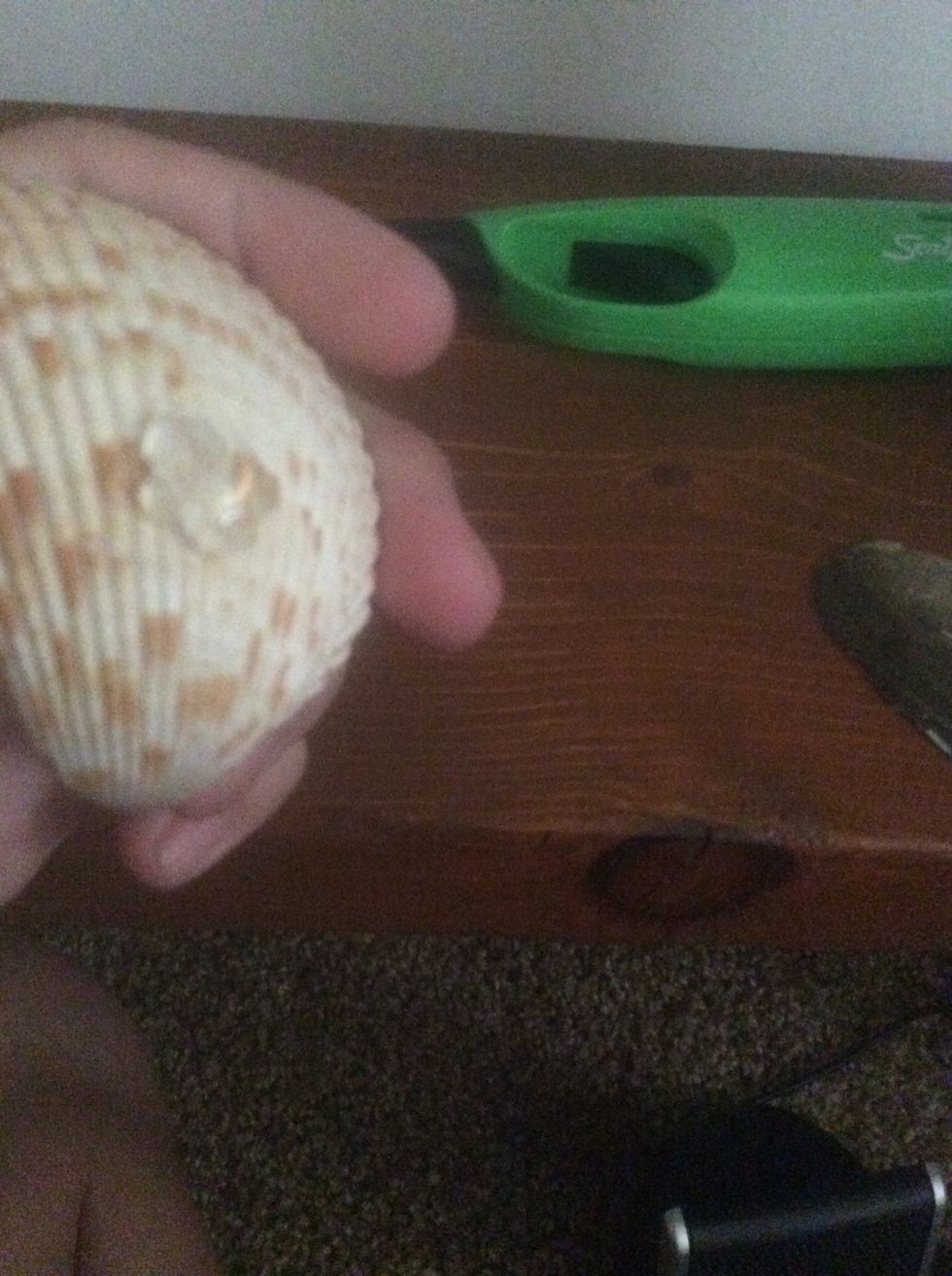 Heat up glue gun and then put a blob of glue on it