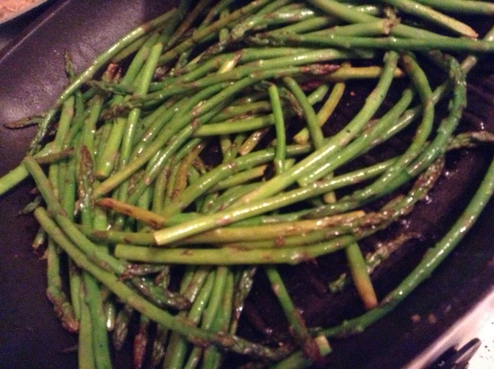 Heat up grill pan then add asparagus -- dress with lemon juice, oil, salt, and pepper -- cook until blackened but still bright green (nobody likes an overcooked asparagus)