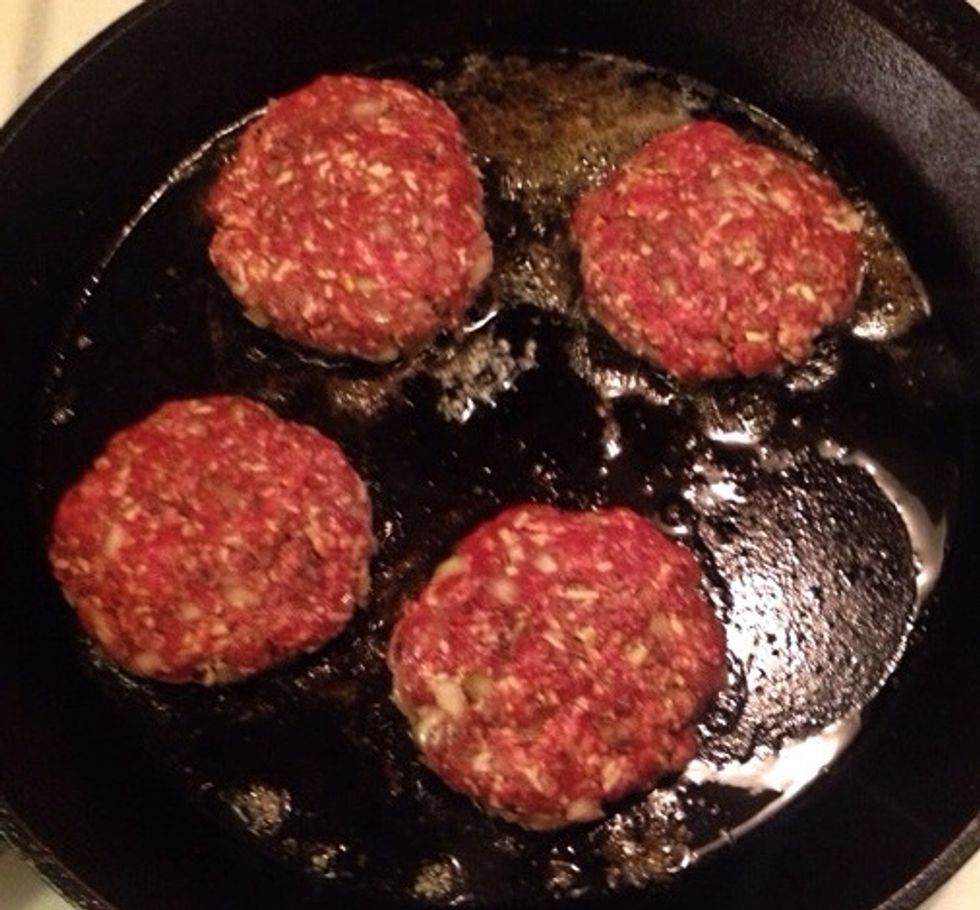 Heat up some olive oil and butter in a skillet. Give the patties some color on each side. Then put them in an oven dish and cook the remaining time in the oven.