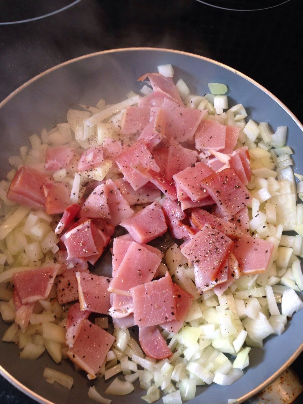 Heat up some olive oil and fry onion with rashers. Add pepper generously.