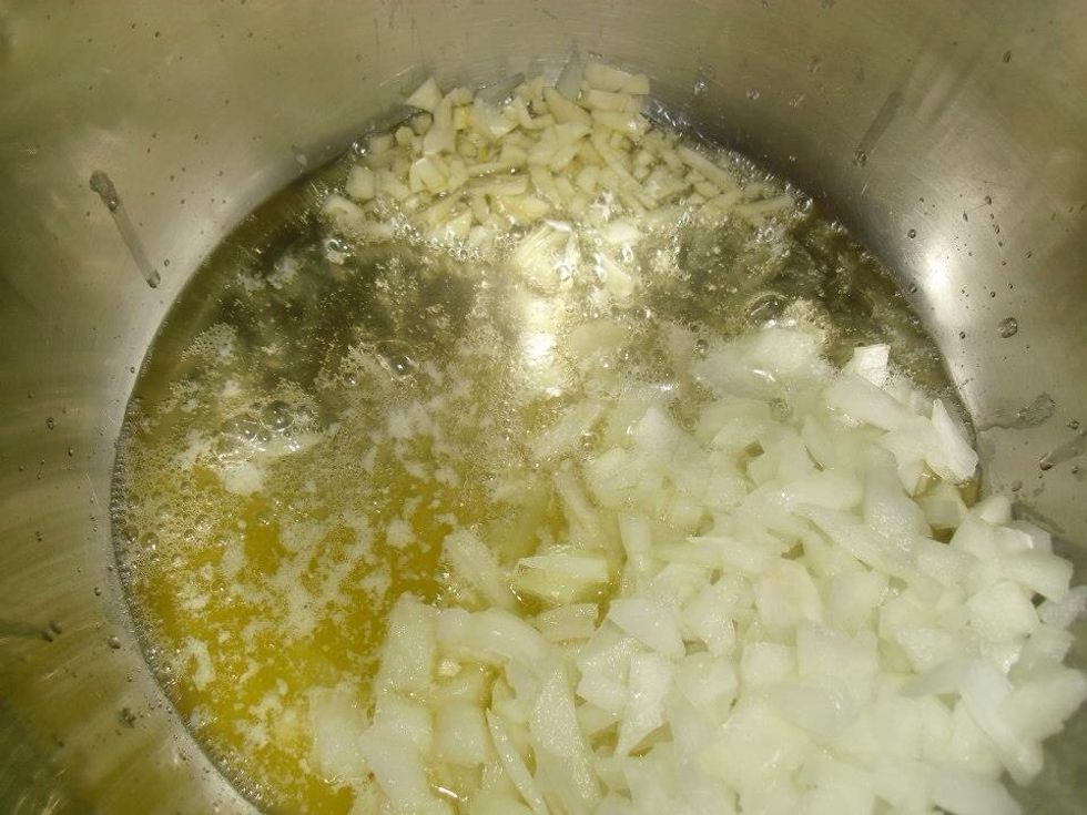 Heat up the butter and the oil in a medium pan and cook the garlic and onions until they're soft but not browned. This should take five to six minutes.
