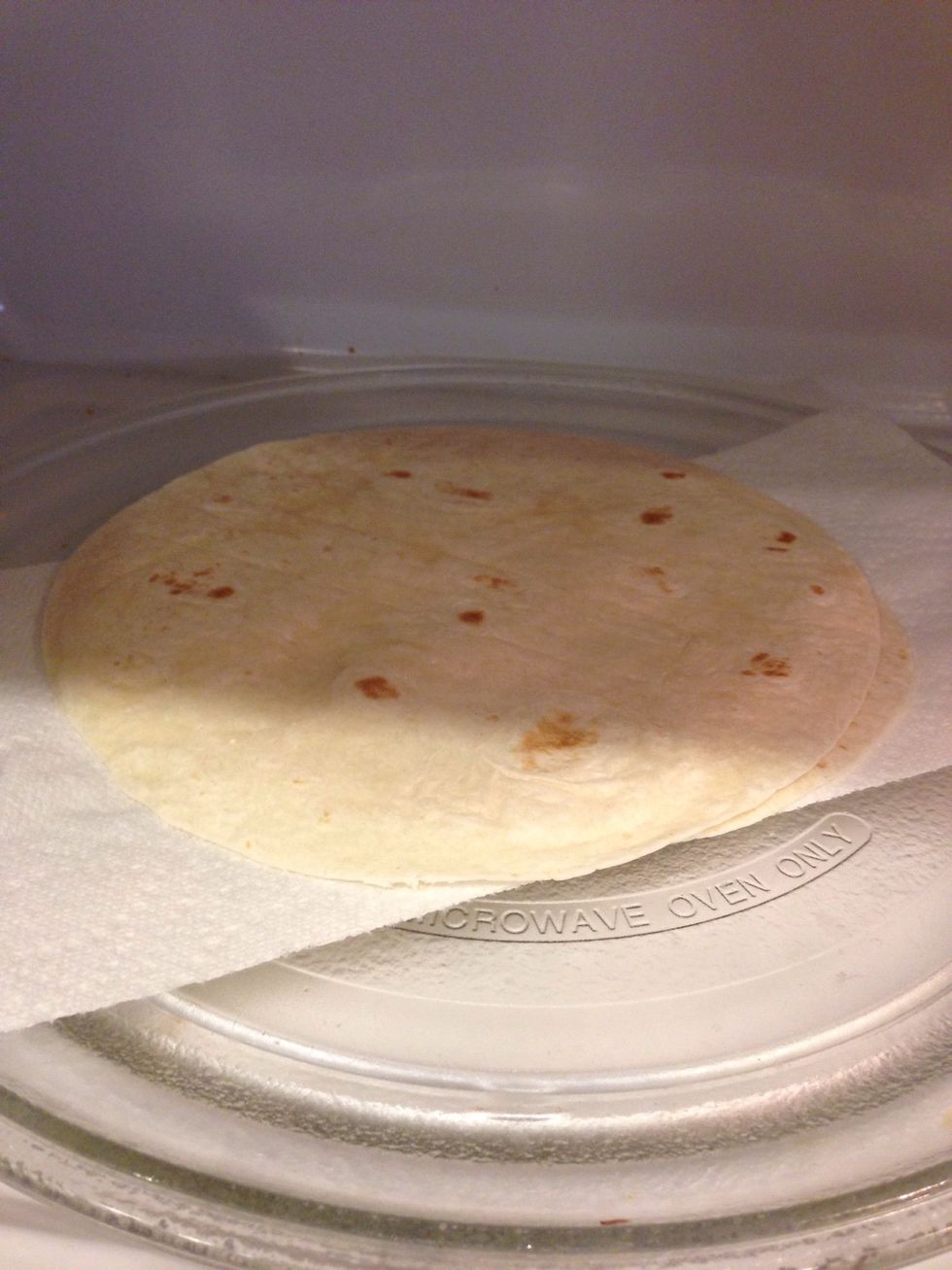 Heat up tortillas in the microwave for 20 seconds.