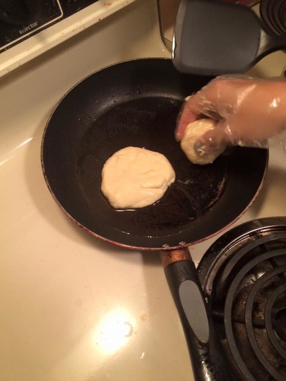 Heat up your non-stick pan over medium heat and add some vegetable oil. Place 1 ball on the pan and let it cook for 30 seconds until the bottom of the dough ball is light golden brown.