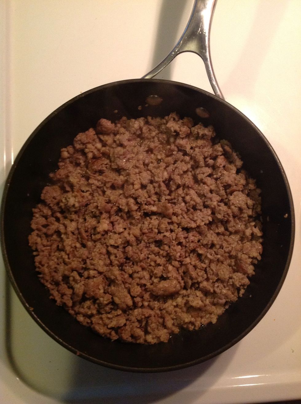 Heat up your skillet at a medium heat and break up your sausage, crumbling and browning until well cooked.