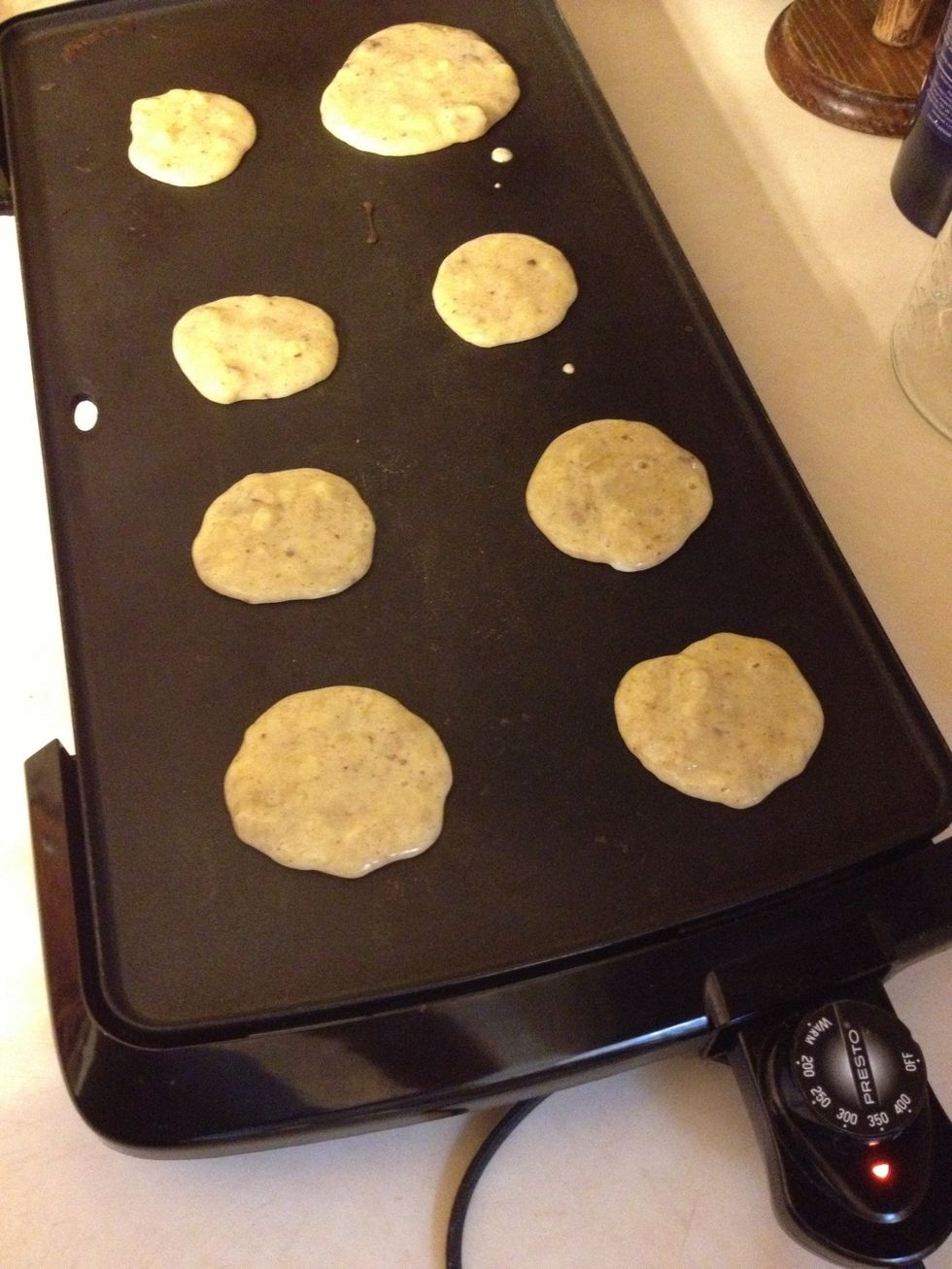 Heat up your skillet to 350 degrees, or if you use a pan I'd say about medium heat. The batter will start to lose its reflective shine when they are ready to be flipped.