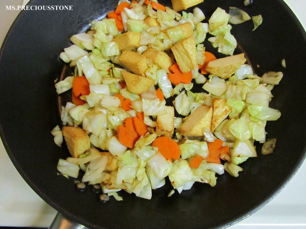 Heat vegetable oil and brown your meat first. Add cabbage, onion and carrot. Saute over medium high heat for a few minutes.
