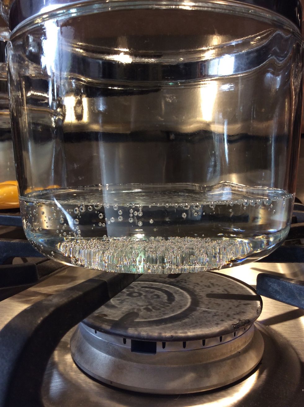 Heat water, bring to a simmer, not a boil. Boiling the water could heat the inside pot too fast and cause the eggs to scramble and not cook.