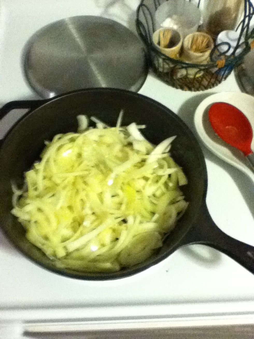 Heat your cast iron over medium high and add a lot of oil, like a quarter cup at least. Then add the chopped onions. You're gonna sweat 'em then brown 'em. Yes, the whole house will smell like onions.