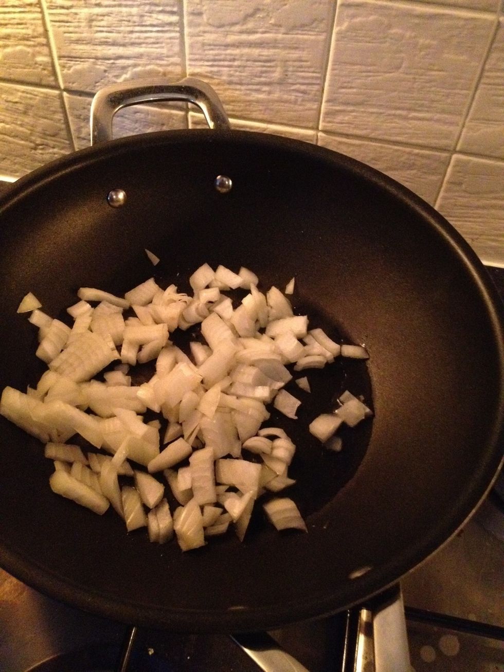 Heat your wok with a tablespoon of oil. Once hot enough to sizzle a drop of water, fry off the onion in the oil. Cook and soften. Add your half teaspoon of cumin seeds. Keep on a medium heat.