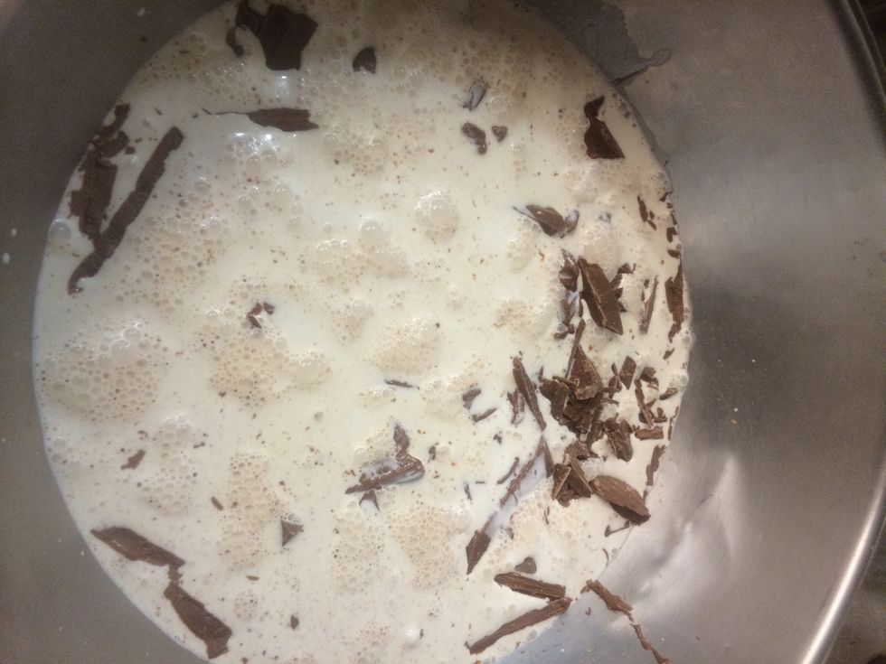 Heavy cream boiled and poured over the chocolate pieces. Let sit a few minutes.