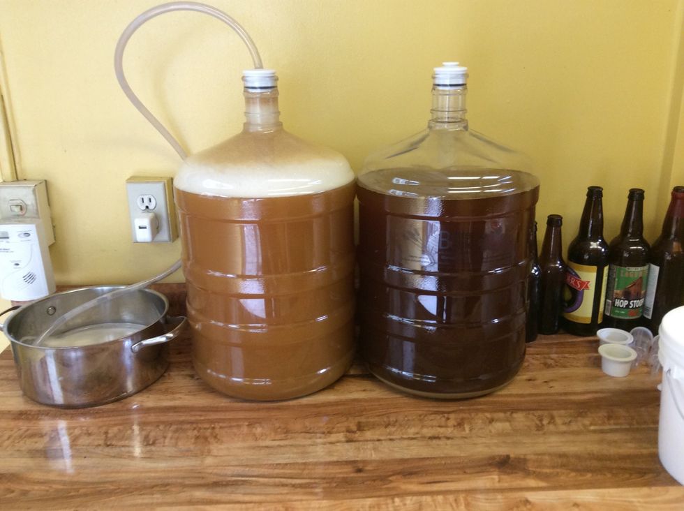 Hefe on the left. Notice the foam. That's krausen. The tube leads to a pot of sterile water. 1st 24 hours do this till the crazy yeast calm down. Then replace with the airlock.