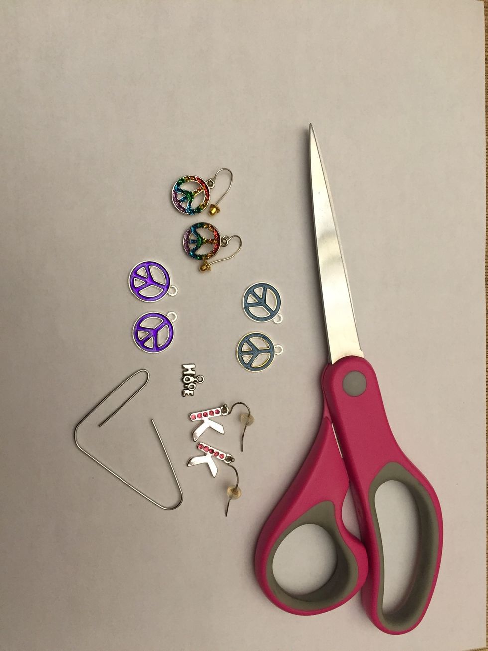 Here are all the materials needed for this craft.  I gathered some dangly earrings I don't usually wear, and some nice charms.  The paper clip is only for those who don't have dangly earrings.