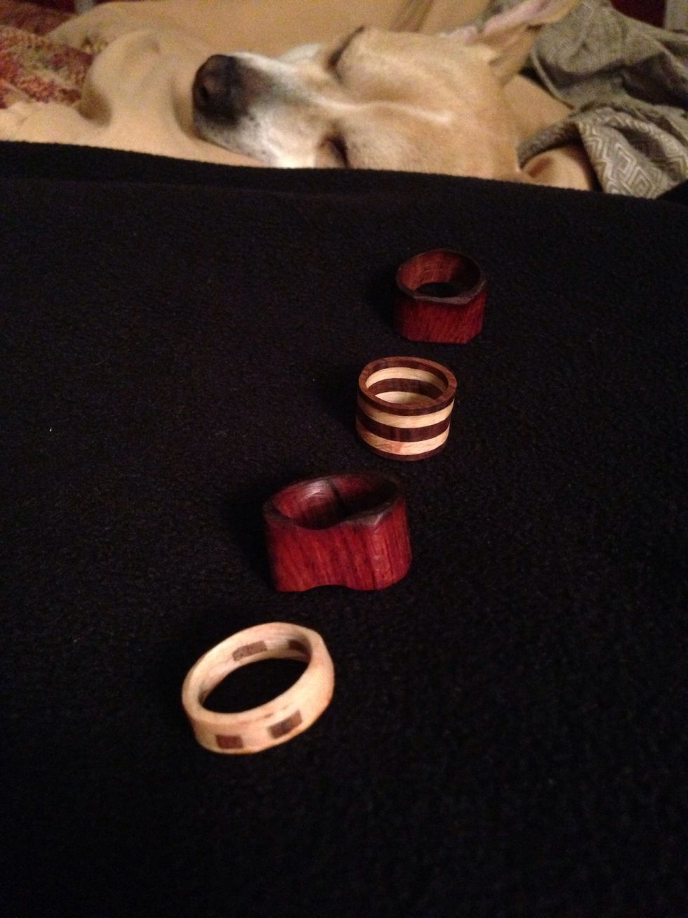 Here are my first four attempts at ring making two are laminated (glued and compressed) and two are solid exotic wood. I will show you how.