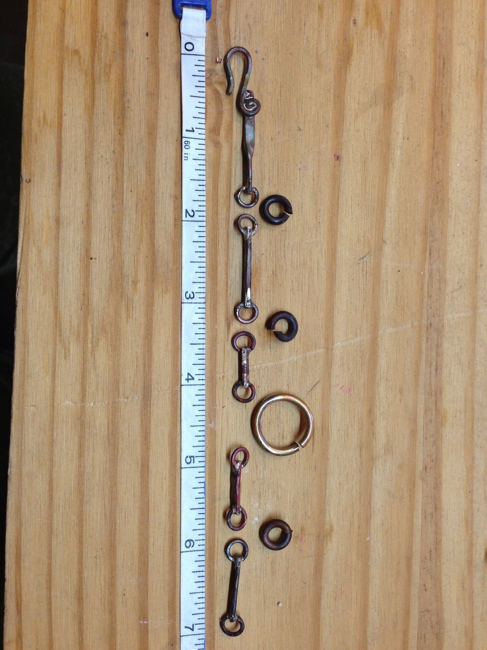 Here are my pieces laid out to see how I'm doing on length. I threw in a large connecting jump ring for fun. I oxidized all the connectors with my torch, so they would look the same.)