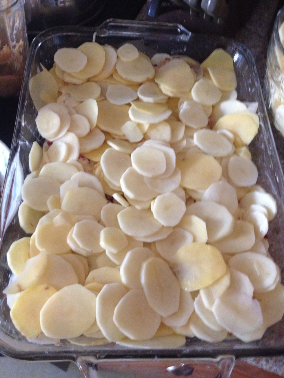 Here are the potatoes ready for the cheesy sauce and bacon. I buttered a 9x13 glass dish and put one layer down of the sliced potatoes.