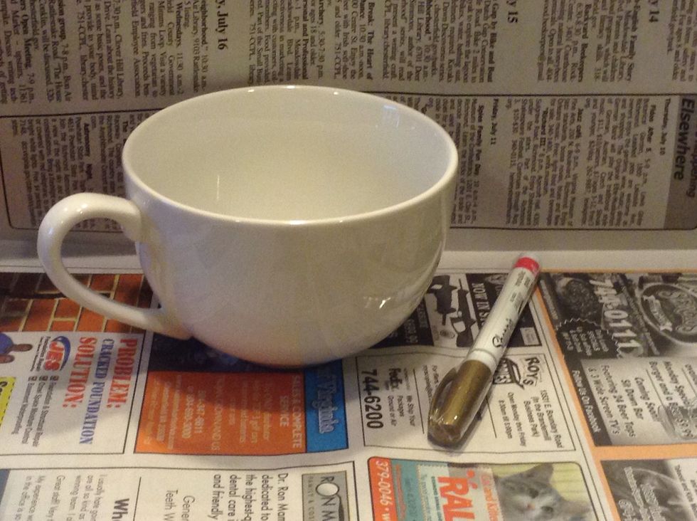Here are the supplies, you will need. Sharpie (oil based only) and a mug. A newspaper underneath will also help to keep messes contained.