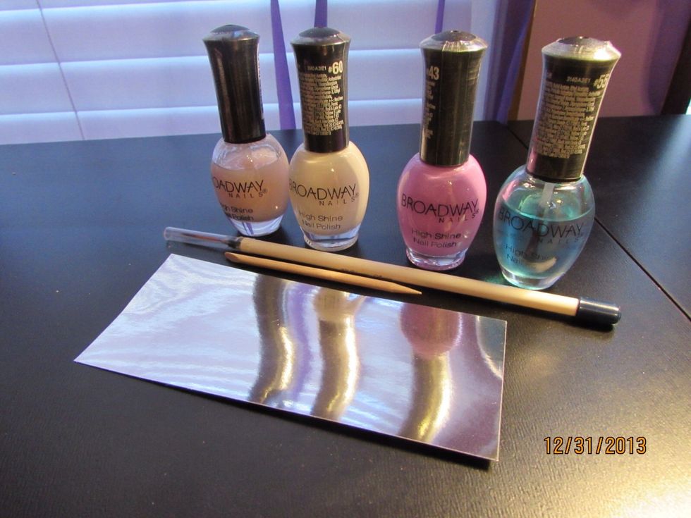Here are the things I will be using.   Base coat, top coat, base color, chevron color, striper, orange stick, and a little foil to blot on nail polish.