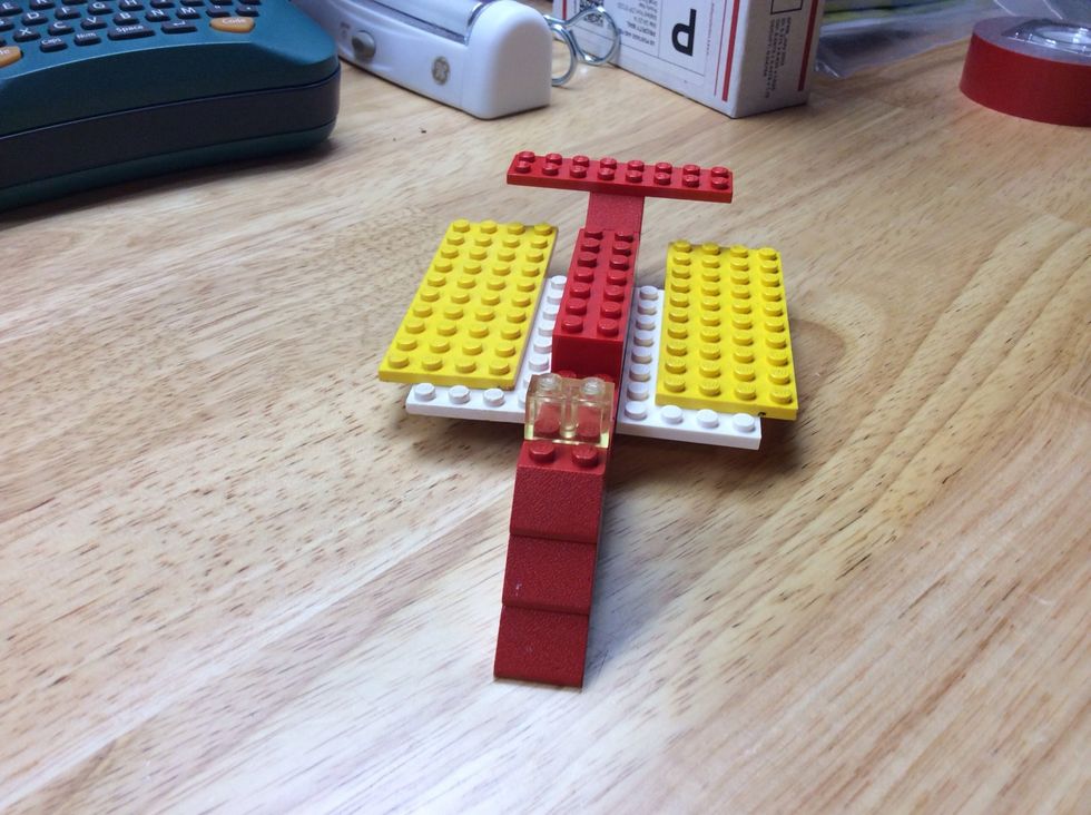 Here at this point, you should add the flat yellow pieces for the second part of the wings, and the clear block to serve as a wind shield.