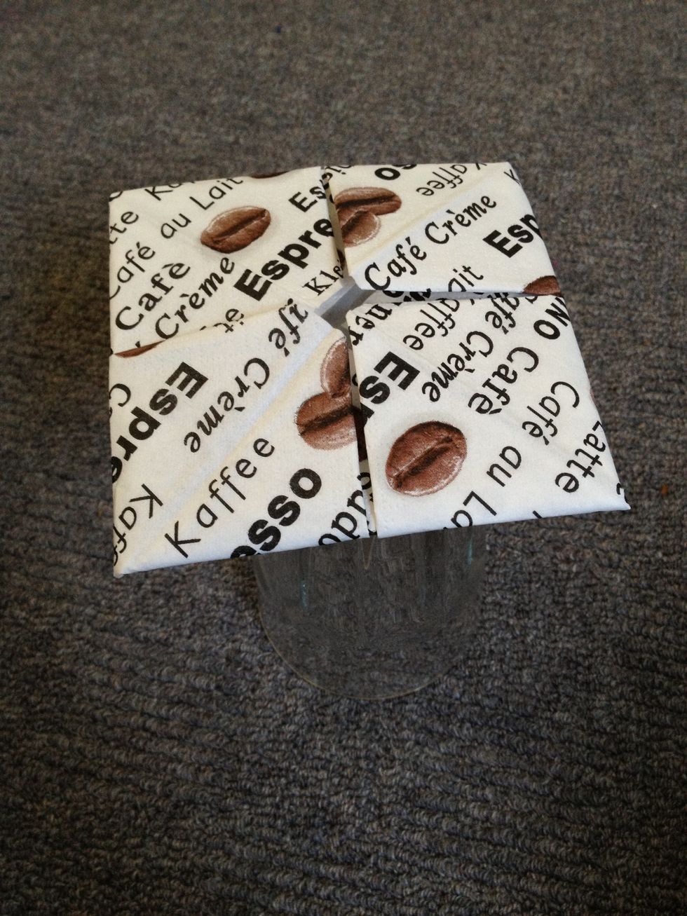 Here comes in the glass. Lay the napkin - flipped upside down - on the glass.