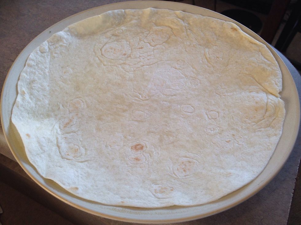 Here comes the fun part, and that's building our burrito. Get your tortilla ready to fill with all of the other awesome ingredients. You can layer it however you like. Here we go!