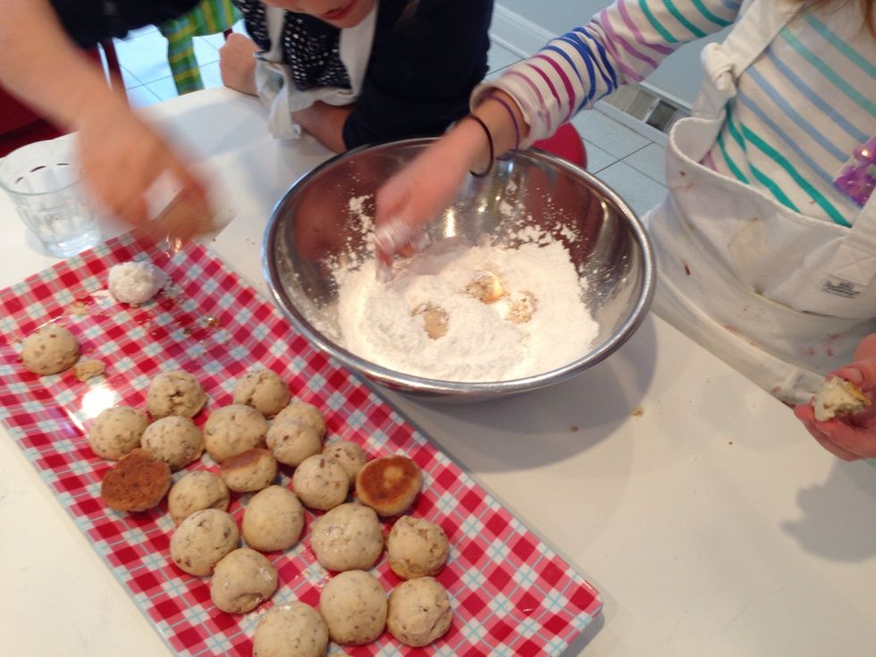 Here, Hadley is demonstrating the bury-the-cookies-then-dig-them-up method of coating the cookies with powdered sugar. You can do them one at a time. Their deliciousness will be the same.