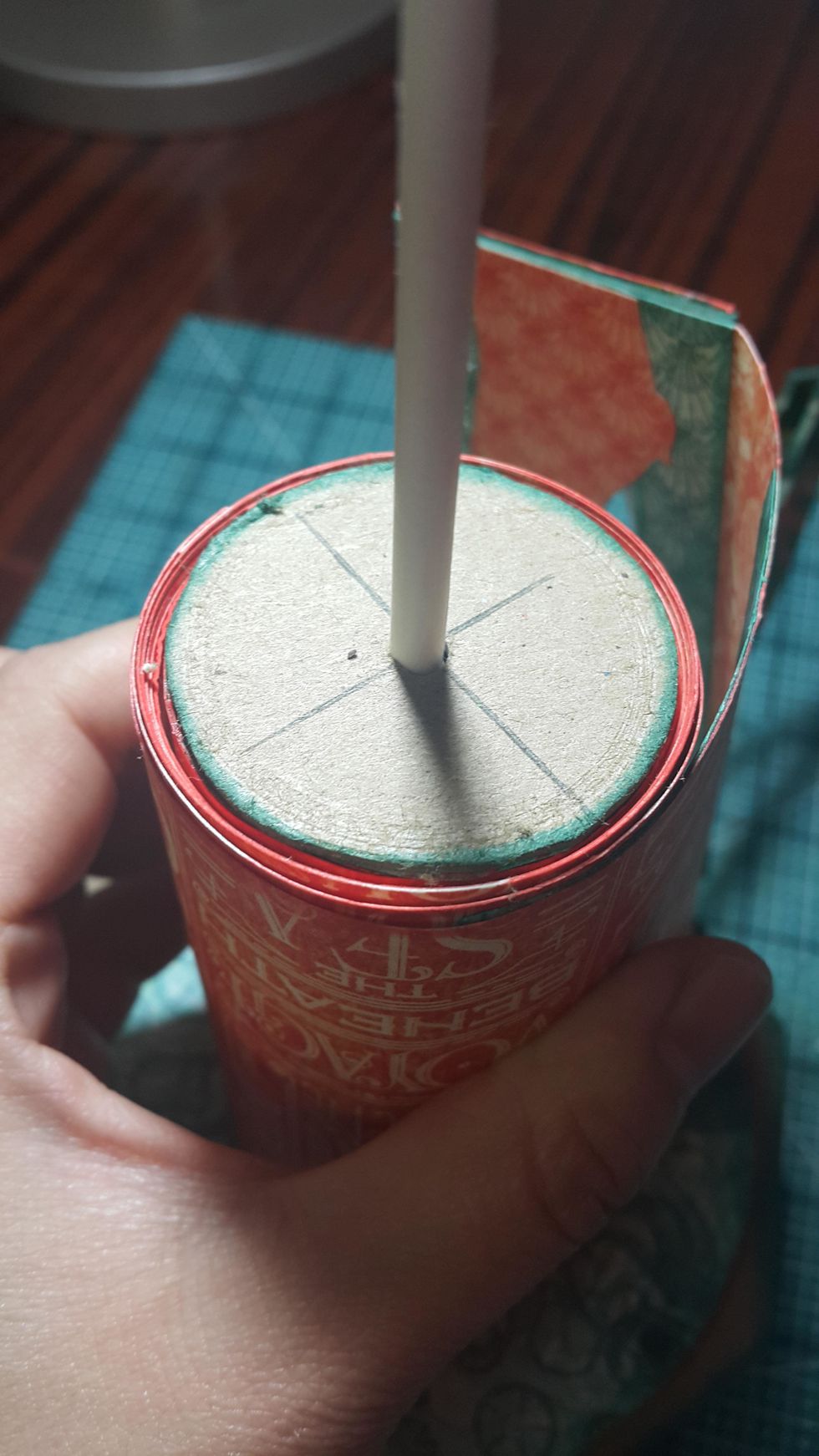 Here how you can go through all the holes, don't cut at this point, use super strong glue to adhere the cotton candy stick with the chipboard, leave dry.