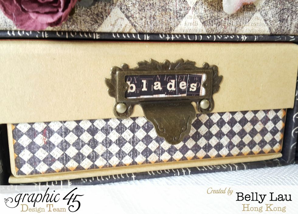 Here I adhere a piece of paper on the front of the mixed media box, and also a metal label holder