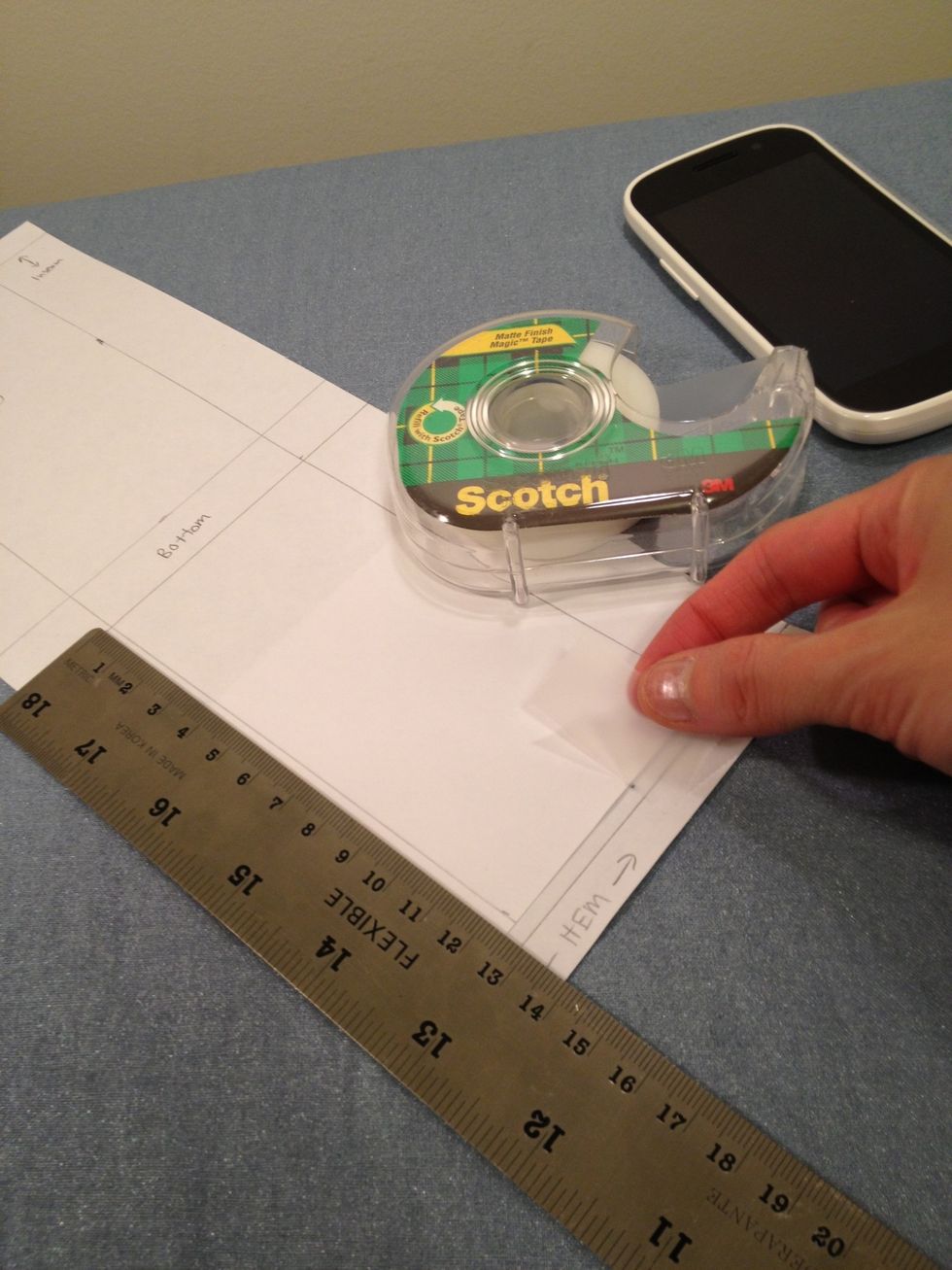 Here I already added a 1cm hem line to the extra paper and I am taping the piece to my current template.