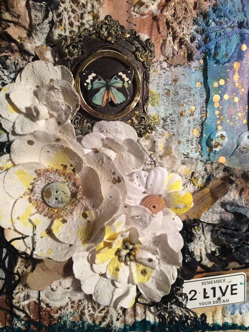 Here I am playing with some other embellishments. Also see the gold splatters on the flowers and paper, that is from a gold pen. I just shake it up then fling it on the surface.