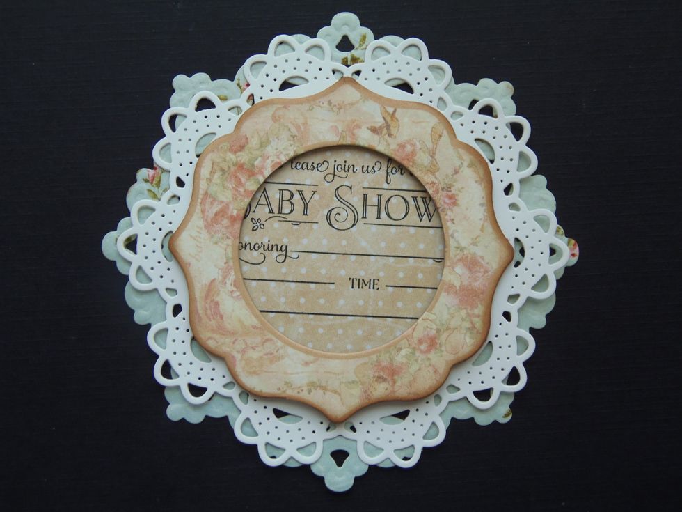 Here I have a chipboard frame that I've centered in front of the white doily. Another option is to use a third- smaller doily in a contrasting color and shape. DO NOT glue them together