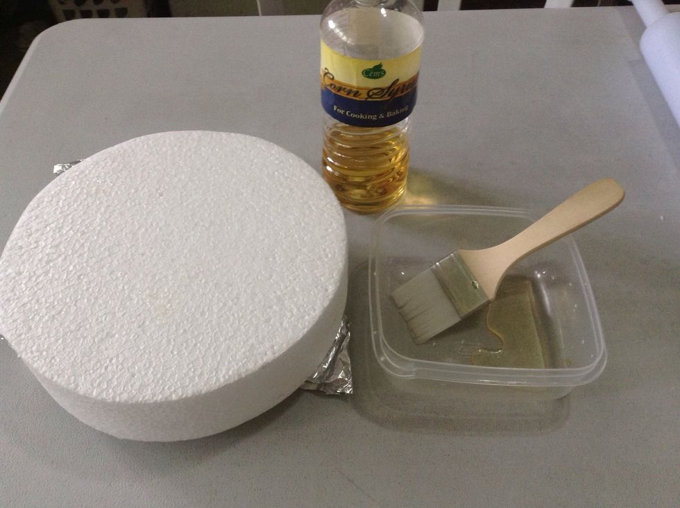 Here I'll be covering my fake cake styro :) using corn syrup I spread abit of it on the styro :)