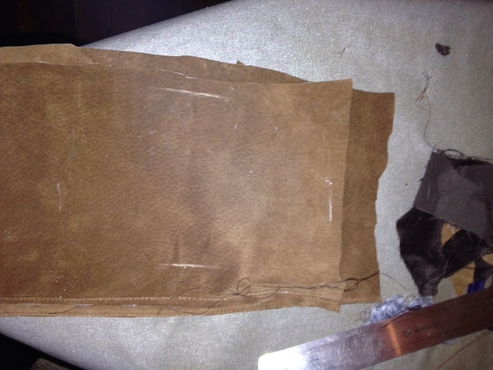 Here I've laid out two more pieces of the suede. I've measured the length and width of the patches I want and marked it out on the top piece in chalk.
