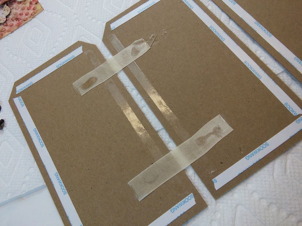 Here I've used small pieces of ribbon as hinges. Since my album will be accordion shaped, I'll just be attaching it between the first two tags.