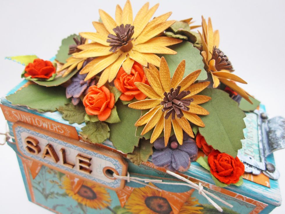 Here is a close up of the cluster of flowers on the top of the cart.