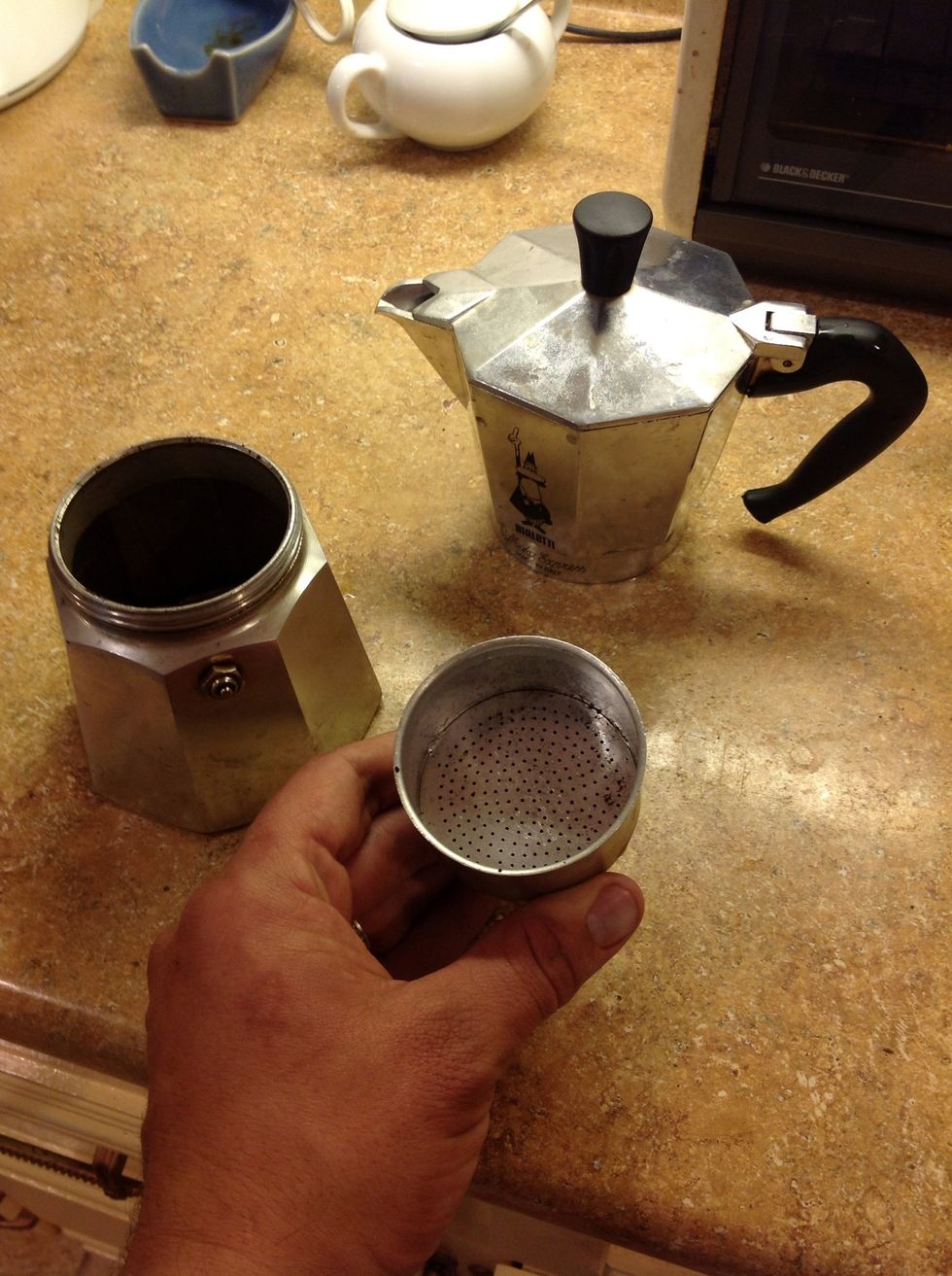 Here is a look at the stovetop espresso maker. The basket I have in my hand is where the coffee goes. It fits in the water well that you see to the left. The finished coffee goes into the pot up top.