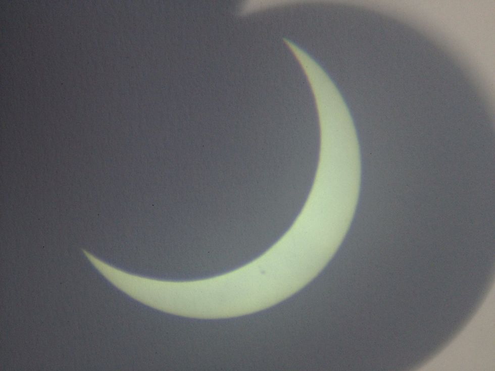 Here is a picture of the eclipse on May 21st. You can see a sunspot too.