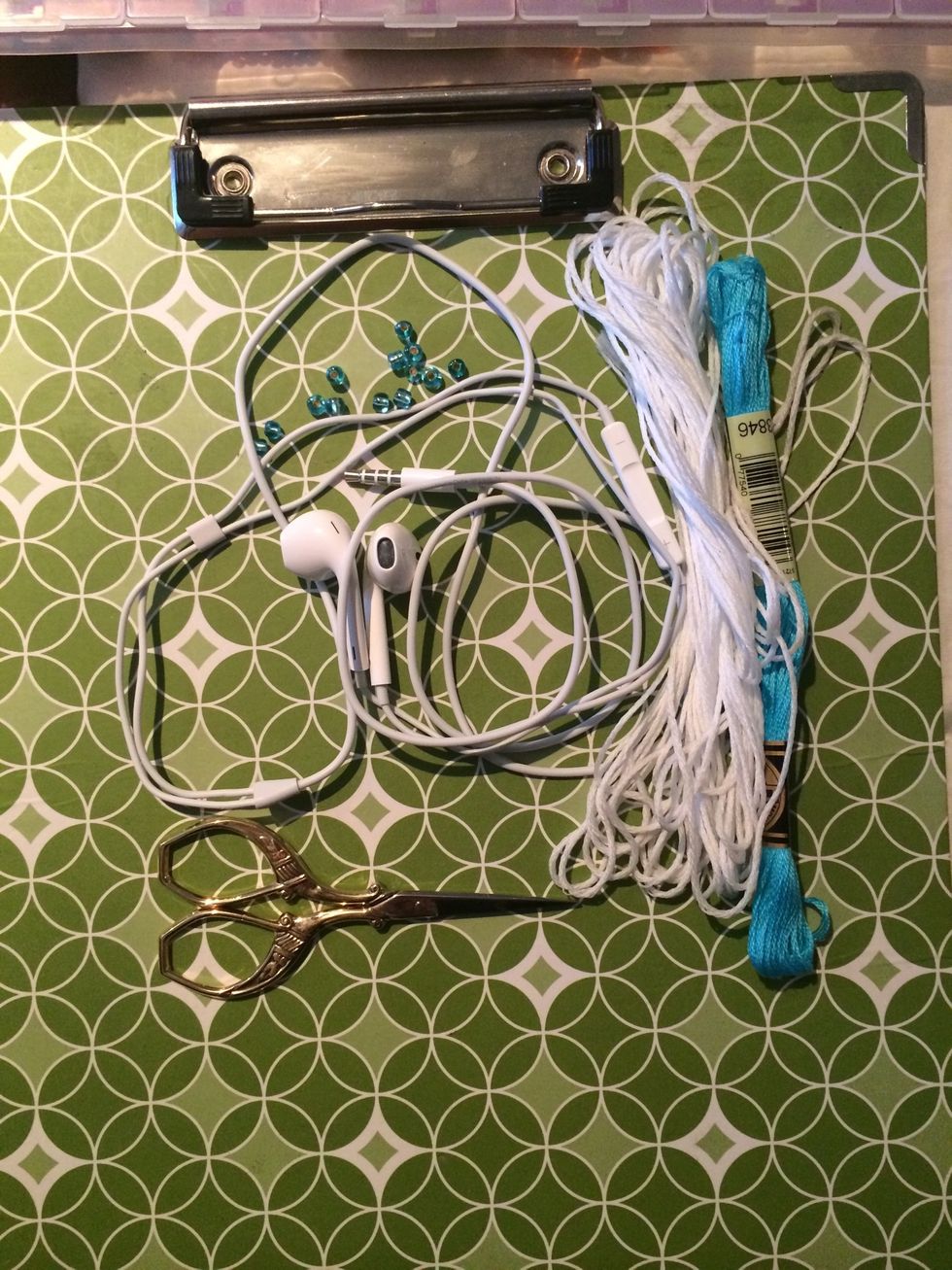 Here is all you will need. Your headphones, some floss, a few beads and a pair of scissors. Let's get started :D You can choose as many colors as you like.
