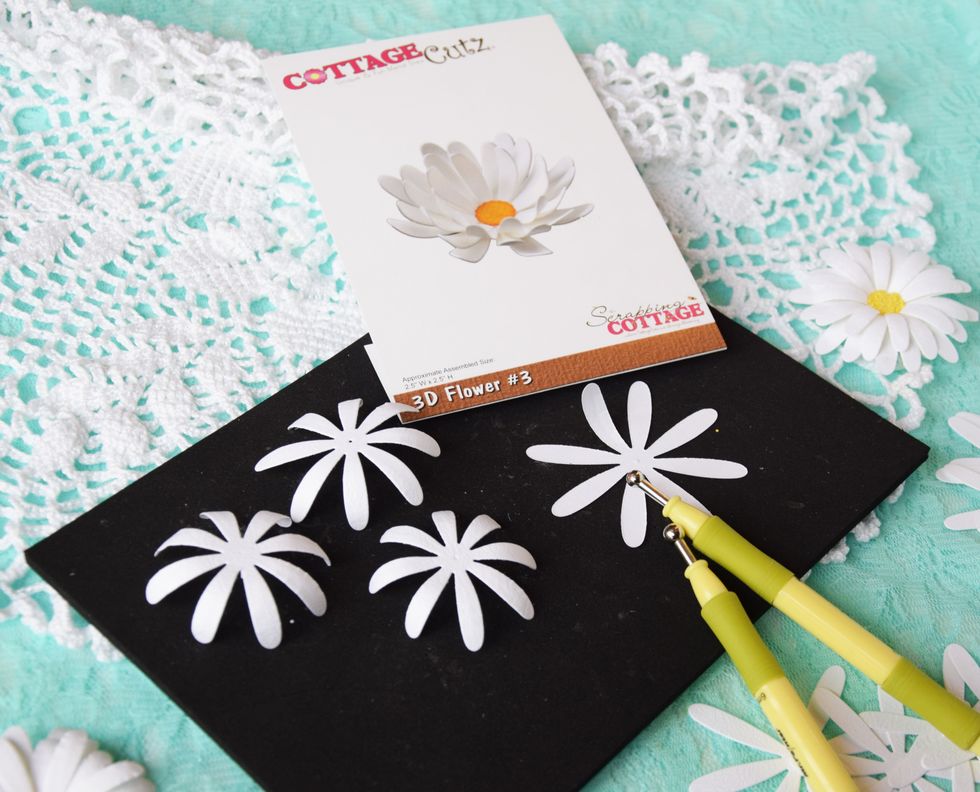 Here is how I put the flower together. The flower has 4 pieces. I die cut them out with paper. I used my special tool to curl the edges to get the fibers lose.